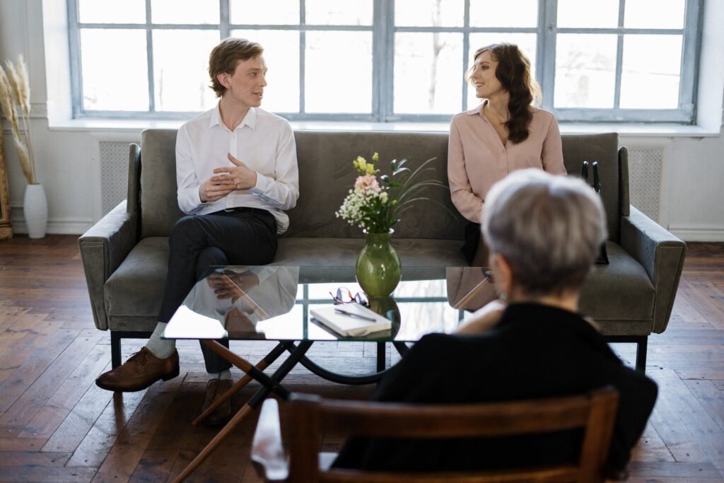 Man in White Dress Shirt Sitting on Gray Couch